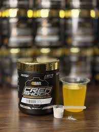 یک قوطی سفید رنگ با برچسب مشکی و نوشتههای نارنجی و سفید. روی قوطی با فونت درشت و برجسته نوشته شده: **SHOCK**. در سطر بعدی با فونت کوچکتر: **LEMON LIME FLAVOUR** و در پایین آن: **NO SUGAR**. این قوطی حاوی پودر کراتین طعمدار لیمو-لایم بدون قند است. ---